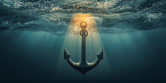 An anchor dropped into the calm ocean with turbulent waves above representing God's Grace in Uncertainty
