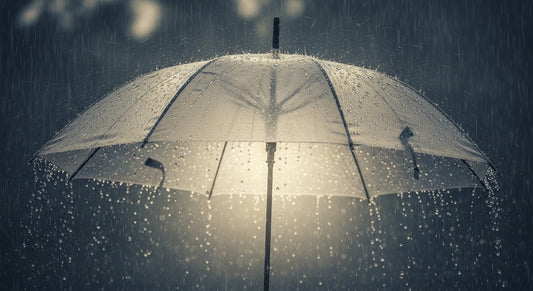 A single umbrella glowing with soft light under heavy rain, symbolizing prayer as shelter during life’s storms.