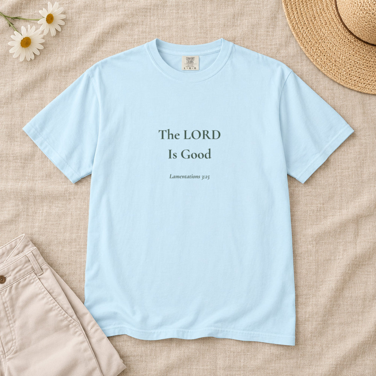 The LORD Is Good Scripture tee in Chambray — styled flat lay